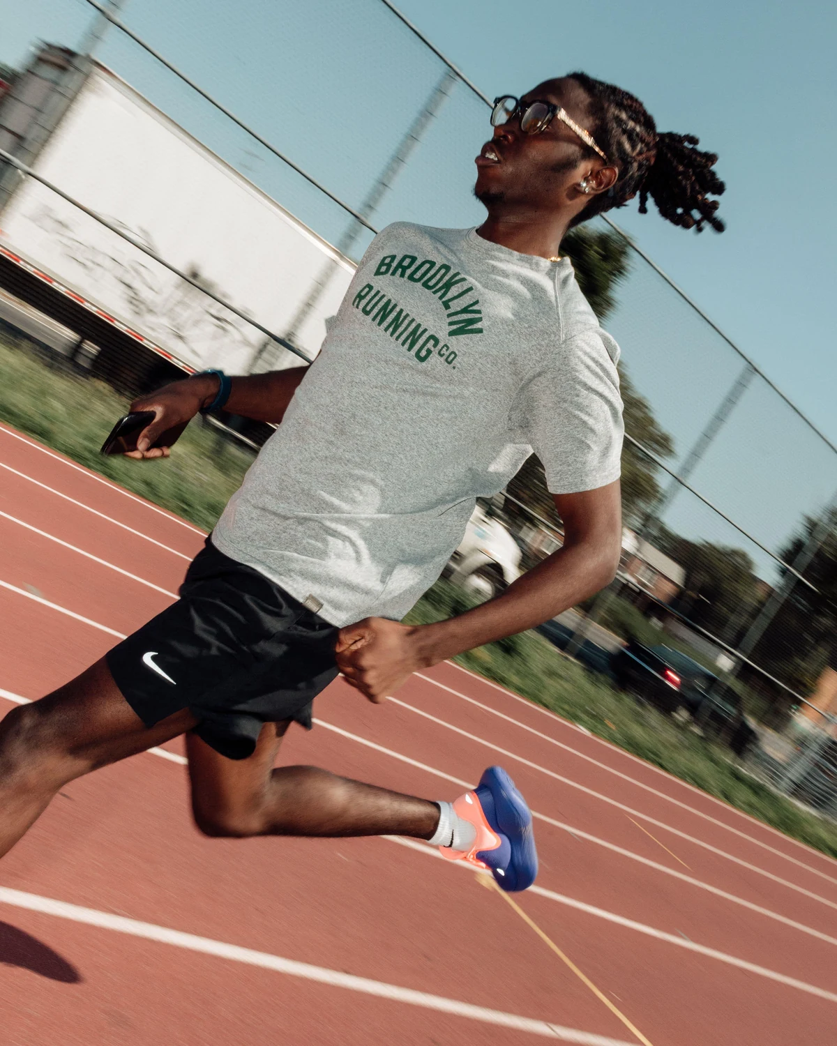 Runner maintaining stride turnover on a track during late marathon cycle workouts